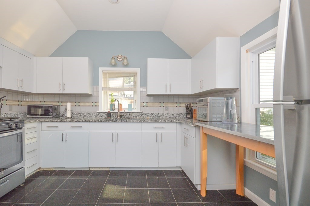 21 Carnes Street Lynn, MA 01905 - Photo 10 of 20 a kitchen with a sink stove and cabinets