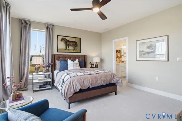 a bedroom with a bed couches and window