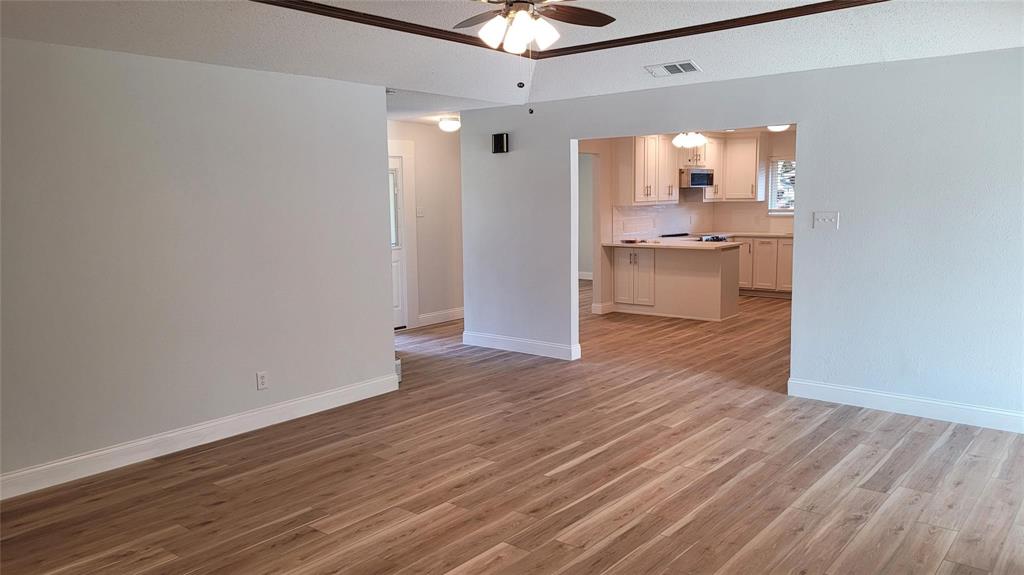 13124 Kerr Trail Farmers Branch, TX 75244 - Photo 13 of 30 a view of kitchen and empty room with wooden floor