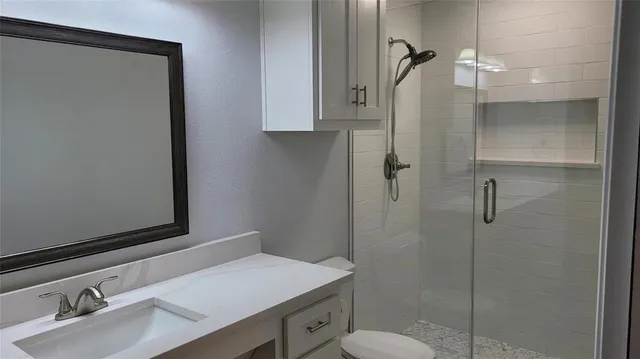 a bathroom with a sink toilet and shower