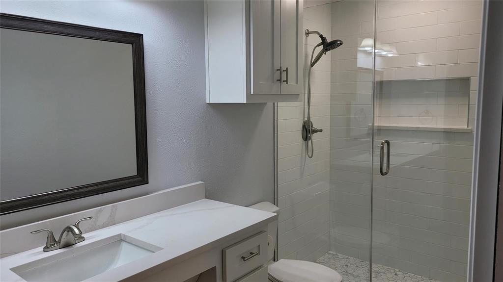 13124 Kerr Trail Farmers Branch, TX 75244 - Photo 15 of 30 a bathroom with a sink toilet and shower