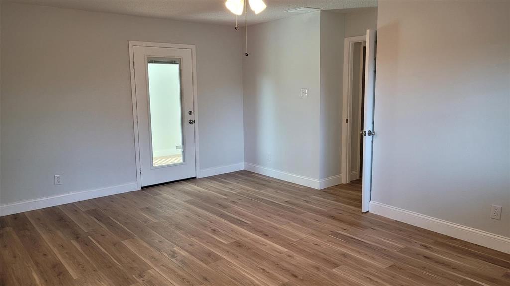 13124 Kerr Trail Farmers Branch, TX 75244 - Photo 21 of 30 a view of an empty room with wooden floor and a window