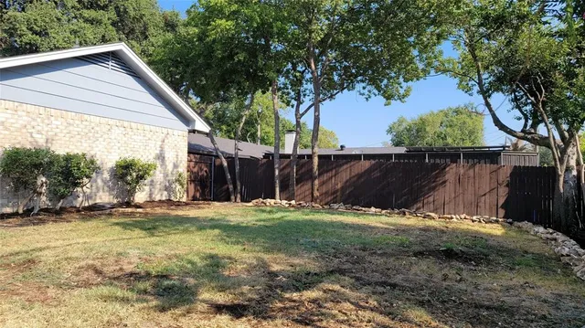 a view of a backyard of the house