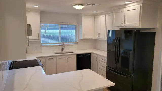 a kitchen with a refrigerator and window