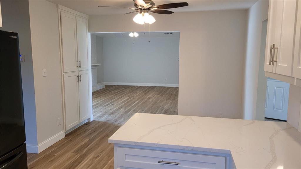 13124 Kerr Trail Farmers Branch, TX 75244 - Photo 9 of 30 a view of a bedroom with wooden floor and a ceiling fan