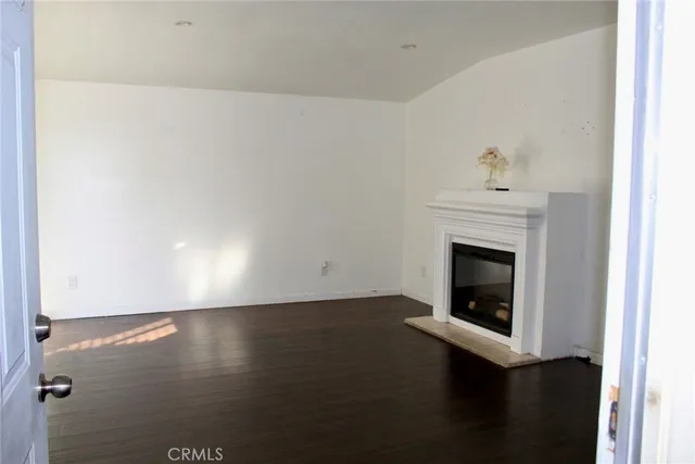 a view of empty room with a fireplace