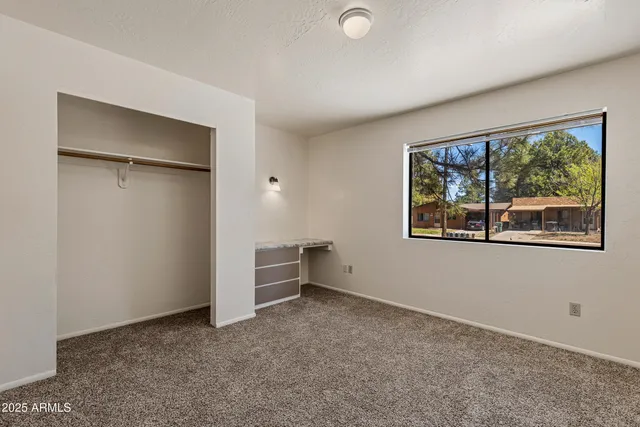 a view of an empty room with closet