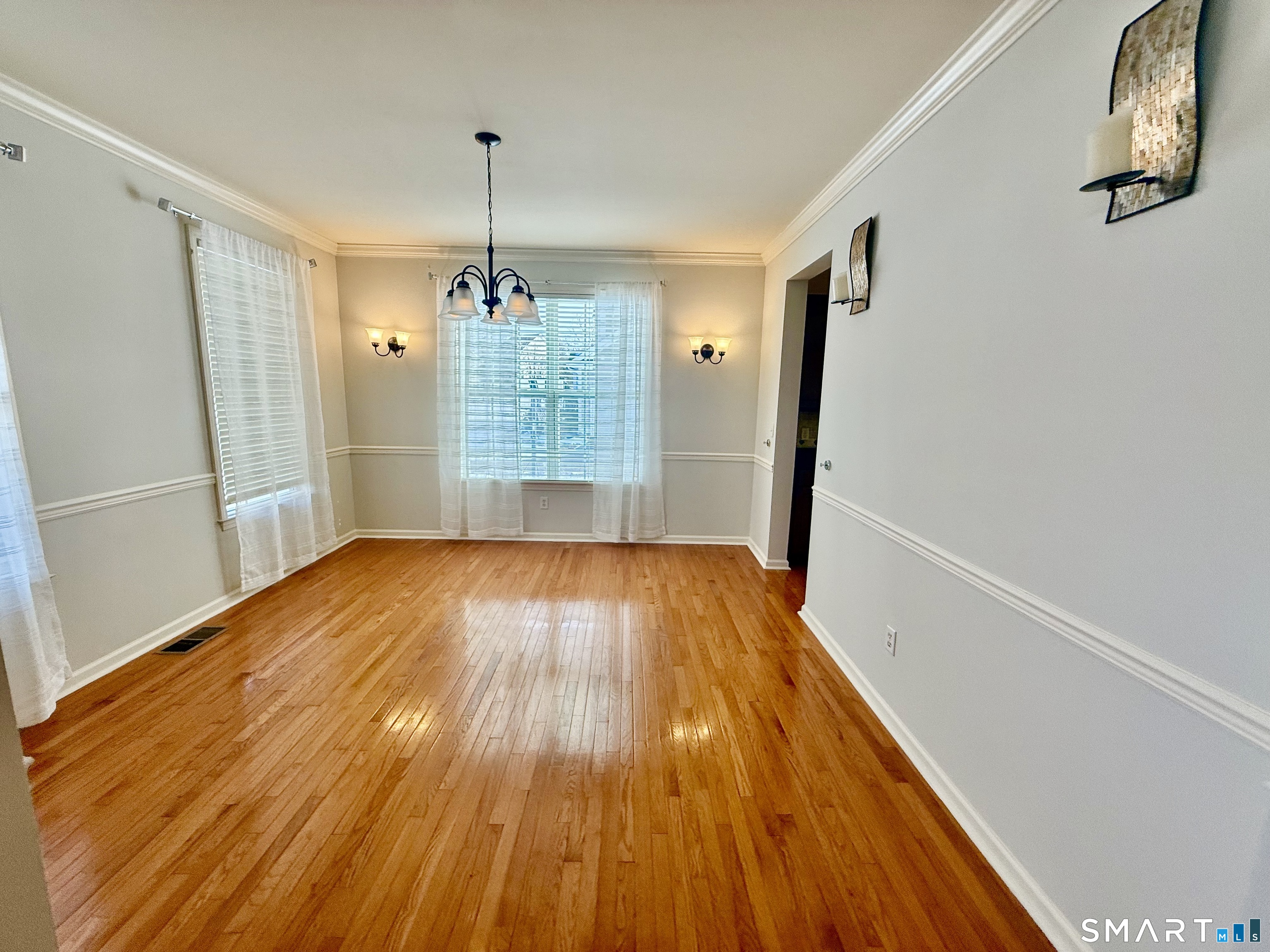 3 Brookside Drive, Unit 3 Middlebury, CT 06762 - Photo 11 of 38 a view of empty room with wooden floor and fan