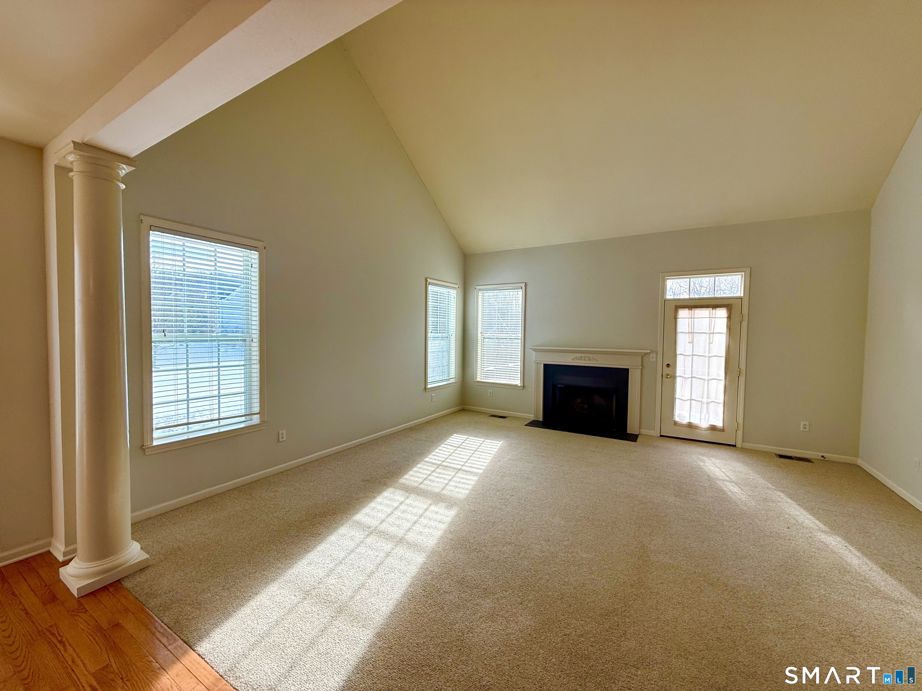 3 Brookside Drive, Unit 3 Middlebury, CT 06762 - Photo 12 of 38 a view of an empty room with window and fire place