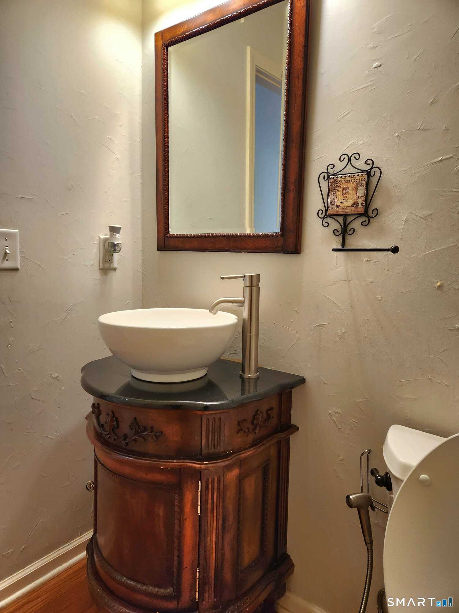 3 Brookside Drive, Unit 3 Middlebury, CT 06762 - Photo 18 of 38 a bathroom with a toilet sink and mirror