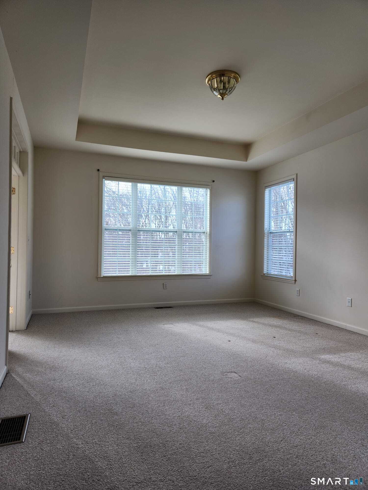 3 Brookside Drive, Unit 3 Middlebury, CT 06762 - Photo 19 of 38 an empty room with a empty space and windows