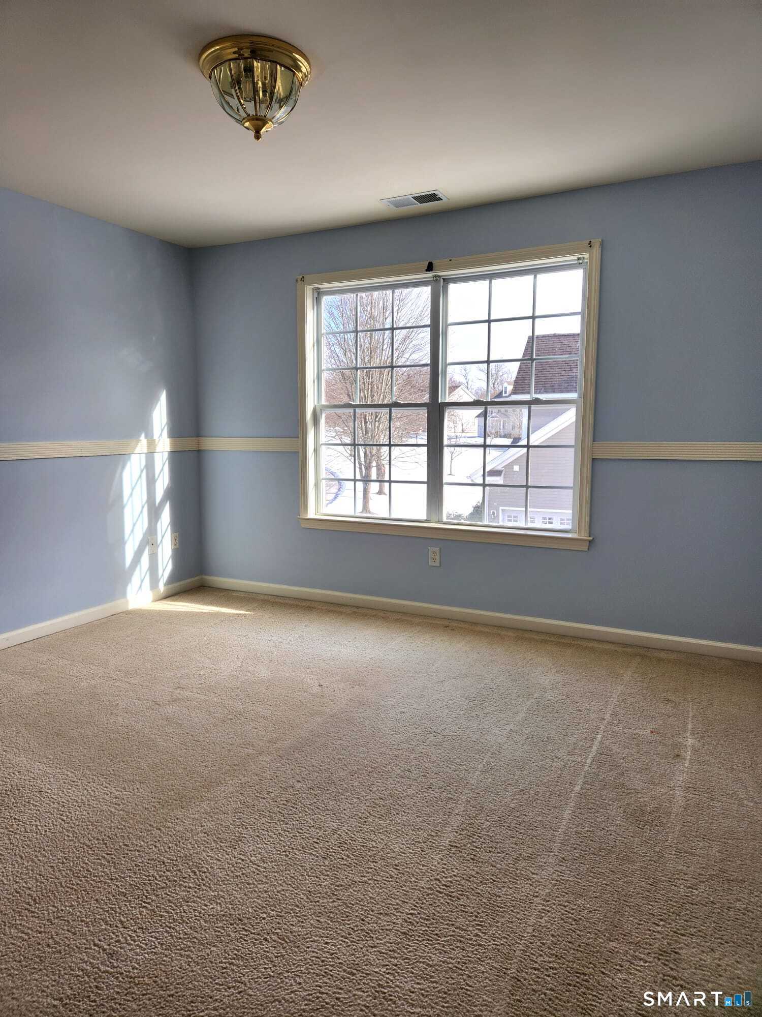 3 Brookside Drive, Unit 3 Middlebury, CT 06762 - Photo 25 of 38 an empty room with a empty space and windows