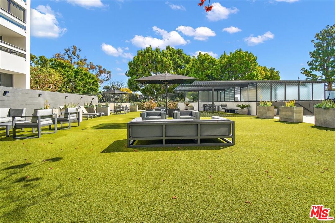 2222 Avenue Of The Stars, Unit 1203 Los Angeles, CA 90067 - Photo 22 of 43 a swimming pool with outdoor seating and yard