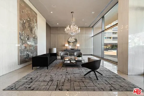 a living room with fireplace furniture and a chandelier