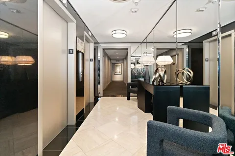 a view of a hallway with paintings on the wall