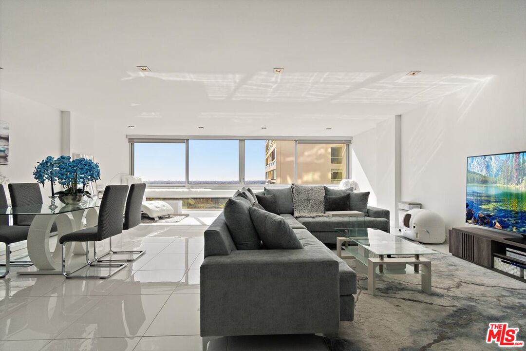 2222 Avenue Of The Stars, Unit 1203 Los Angeles, CA 90067 - Photo 6 of 43 a living room with furniture and a large window