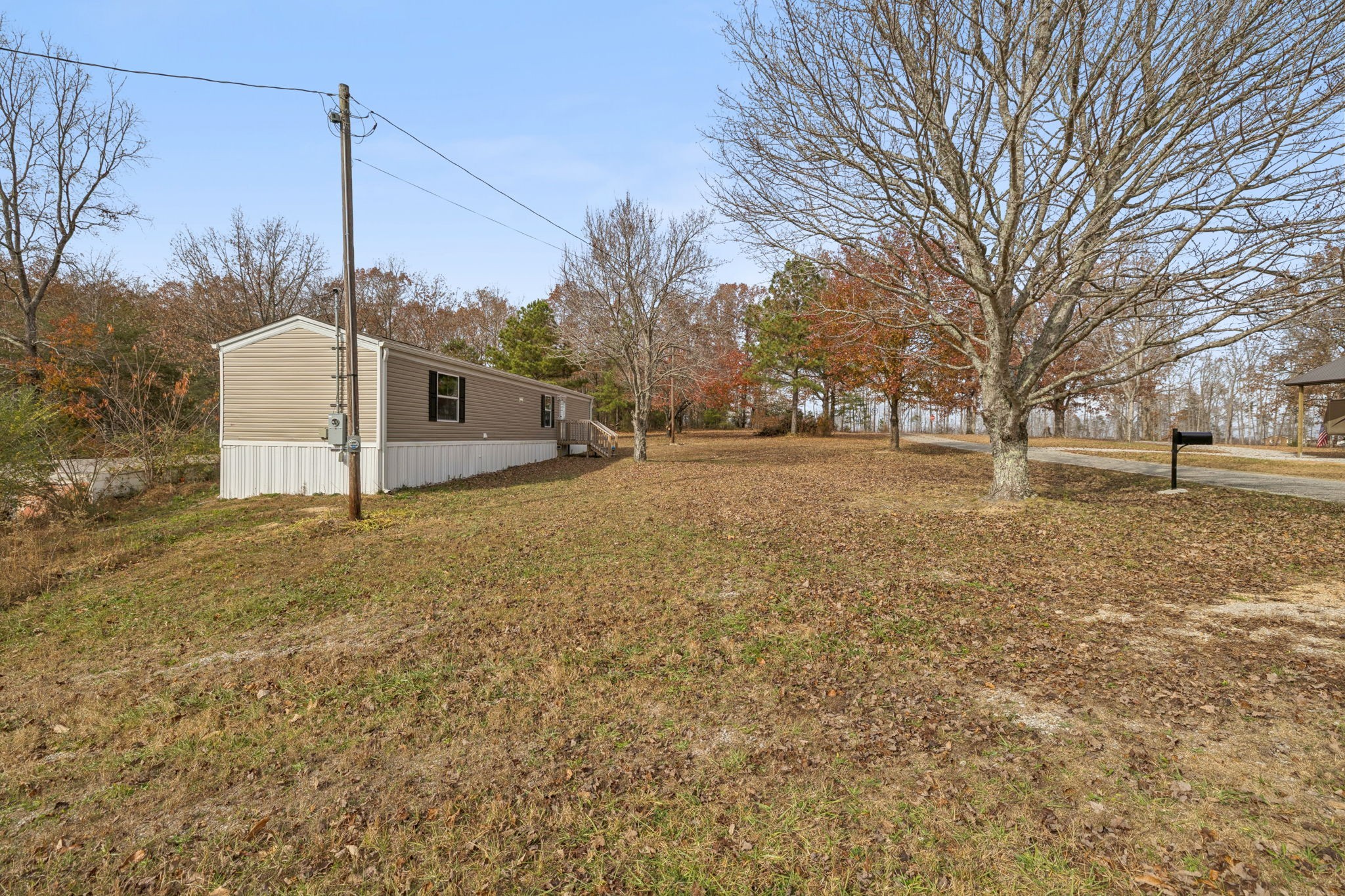 108 Lyell Road Hohenwald, TN 38462 - Photo 2 of 28 a view of a field with trees in the background