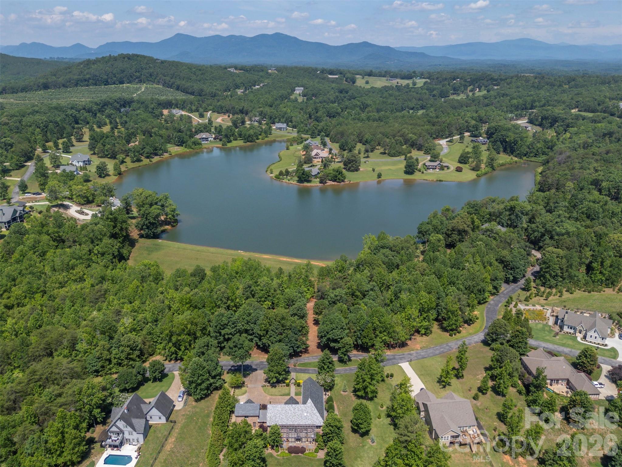 0 Doveridge Drive, Unit 66 Tryon, NC 28782 - Photo 3 of 21 an aerial view of lake residential houses with outdoor space and lake view