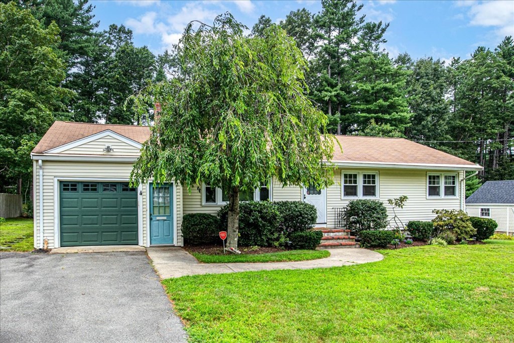 23 Old Post Road East Walpole, MA 02032 - Photo 1 of 27 a front view of a house with a garden and plants