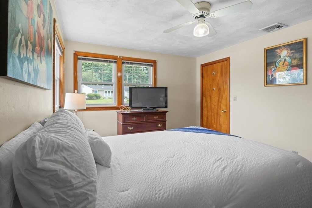23 Old Post Road East Walpole, MA 02032 - Photo 20 of 27 a bedroom with a bed and a tv on the dresser