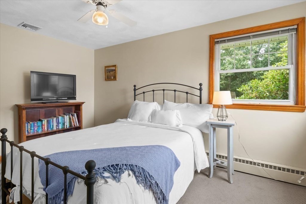 23 Old Post Road East Walpole, MA 02032 - Photo 21 of 27 a bedroom with a bed window and a flat screen tv