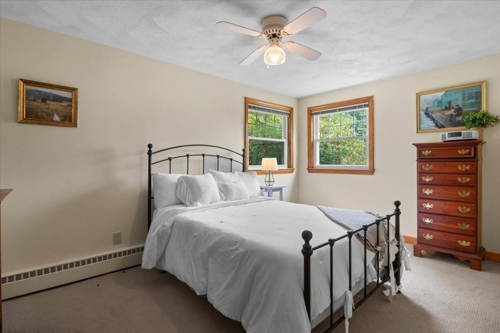 23 Old Post Road East Walpole, MA 02032 - Photo 22 of 27 a bedroom with a bed chandelier and a window