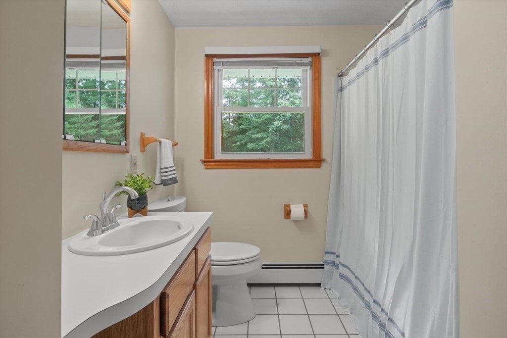 23 Old Post Road East Walpole, MA 02032 - Photo 23 of 27 a bathroom with a sink a toilet and a window
