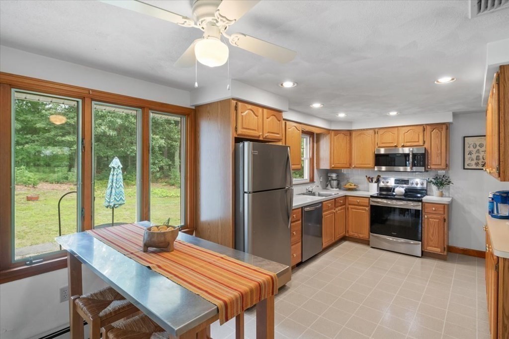 23 Old Post Road East Walpole, MA 02032 - Photo 8 of 27 a kitchen with refrigerator cabinets and dining table