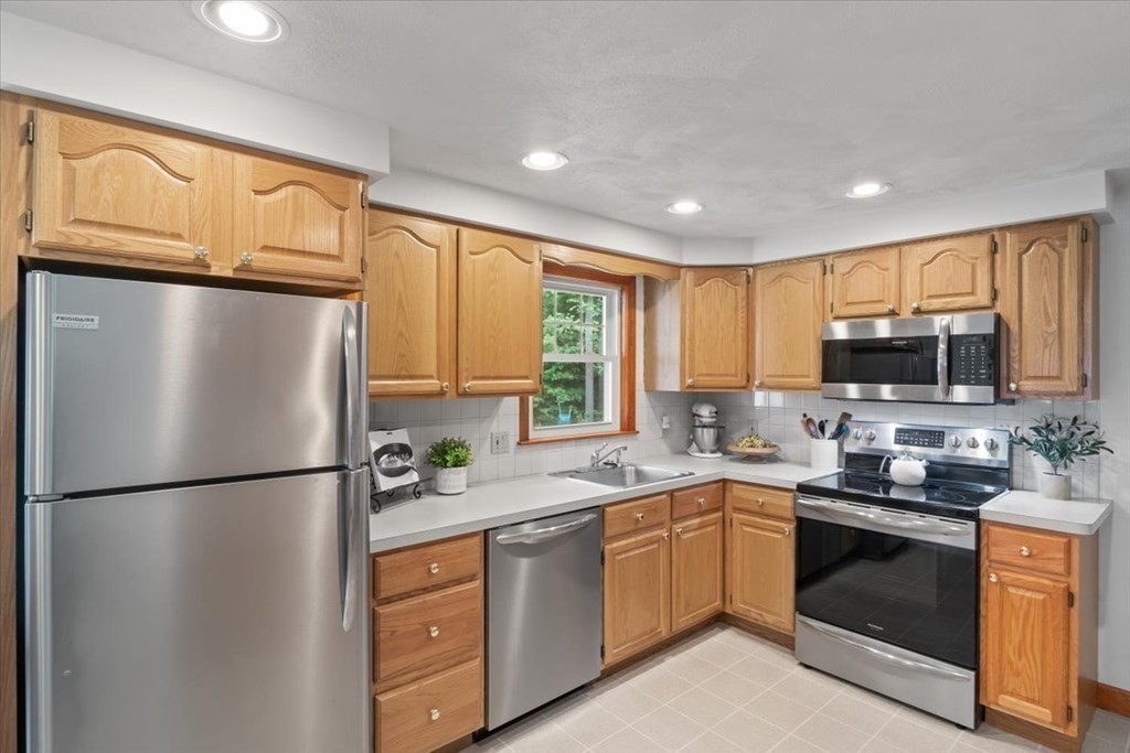 23 Old Post Road East Walpole, MA 02032 - Photo 10 of 27 a kitchen with stainless steel appliances granite countertop a refrigerator a sink dishwasher a refrigerator cabinets and wooden floor
