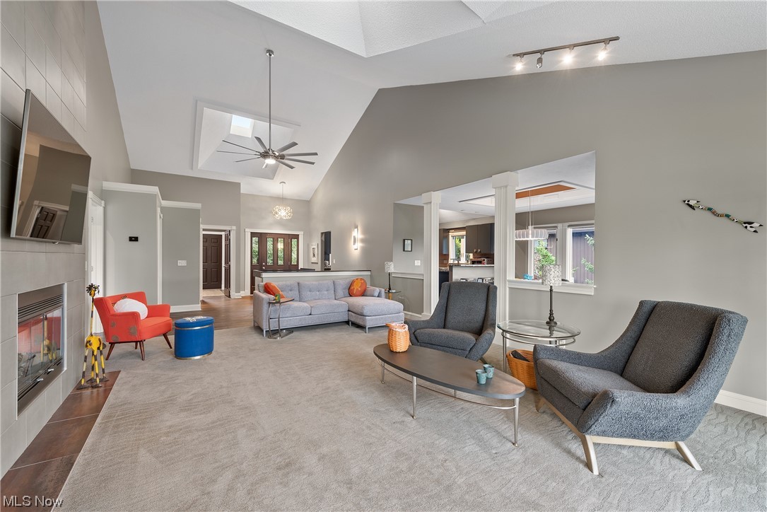 3718 Fenn Road Medina, OH 44256 - Photo 7 of 35 Living room with a fireplace, rail lighting, ceiling fan, and high vaulted ceiling