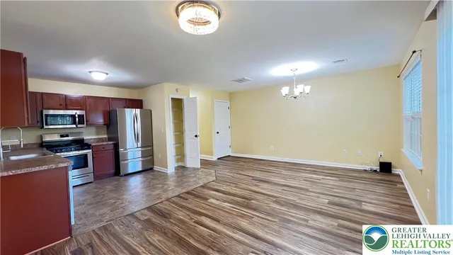 a view of a kitchen with a sink and a refrigerator