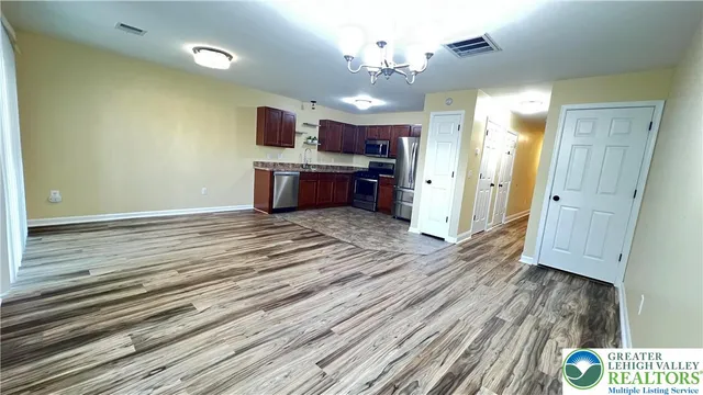 a view of a kitchen with a sink and wooden floor