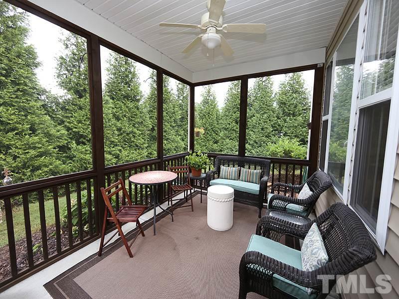 2827 Casona Way Raleigh, NC 27616 - Photo 14 of 25 Enjoy a morning coffee or a cool drink on the screen porch. Note the wall of mature Leland Cyprus providing complete privacy.