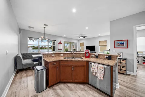 a open kitchen with stainless steel appliances granite countertop a sink and cabinets