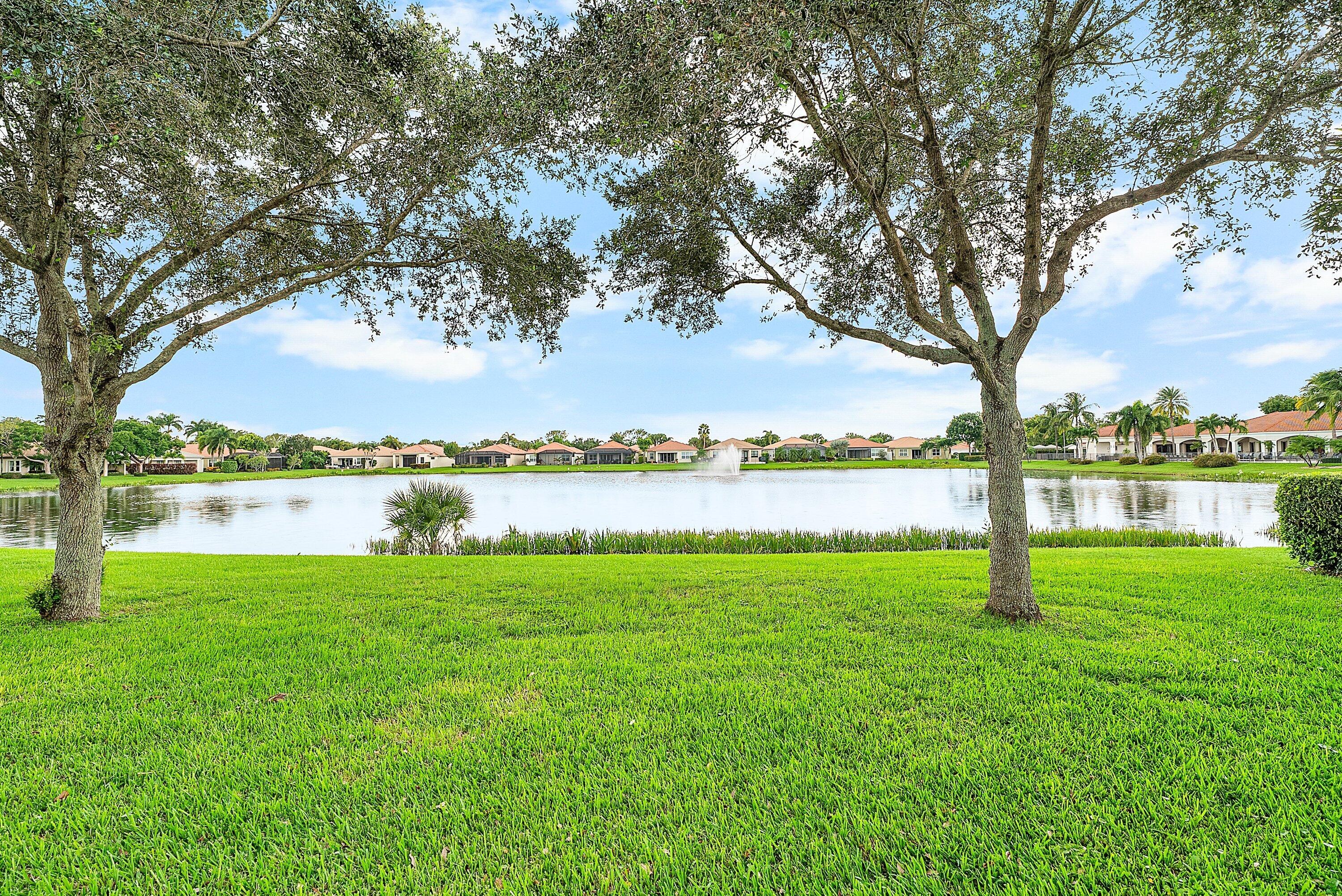 14841 Strand Lane, Unit 14841 Delray Beach, FL 33446 - Photo 33 of 43 a view of lake with green field and trees