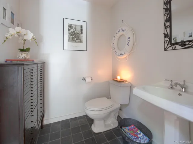 a bathroom with a toilet a sink and a mirror