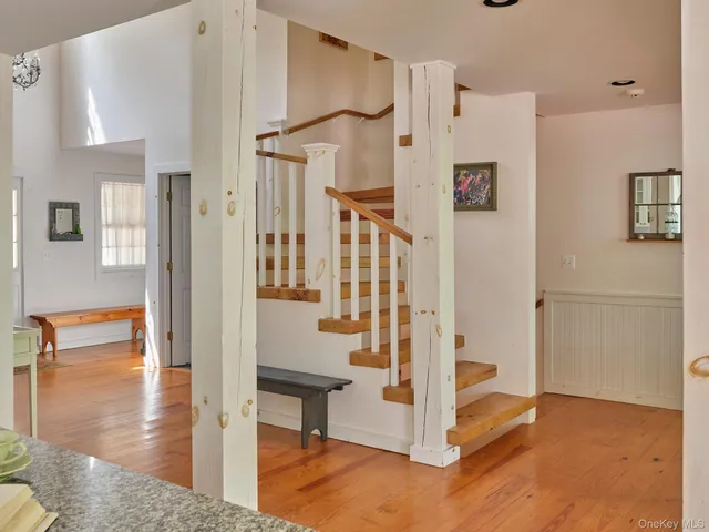 a view of entryway with wooden floor and dining room