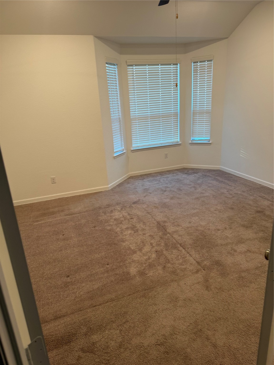 2911 Cooper Hawk Lane Richmond, TX 77406 - Photo 12 of 27 an empty room with windows