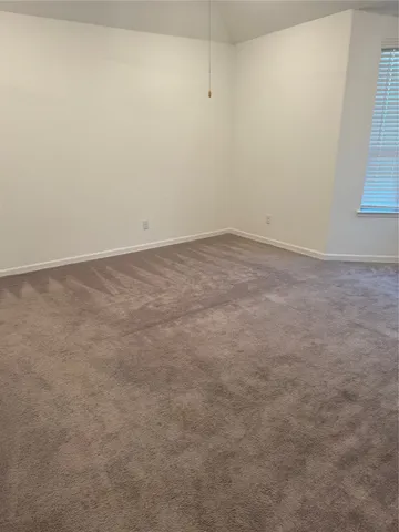 an empty room with a empty space and windows