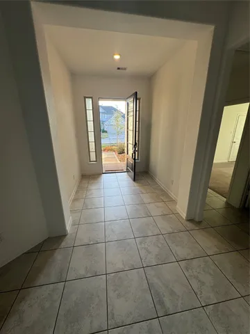a view of a livingroom with an empty space and a window