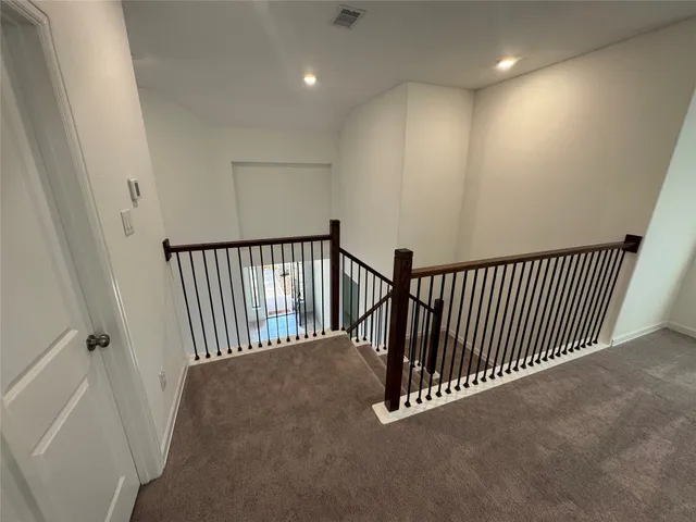 a view of a hallway with a white door