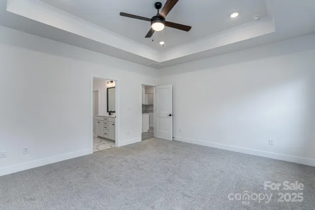 an empty room with closet and windows