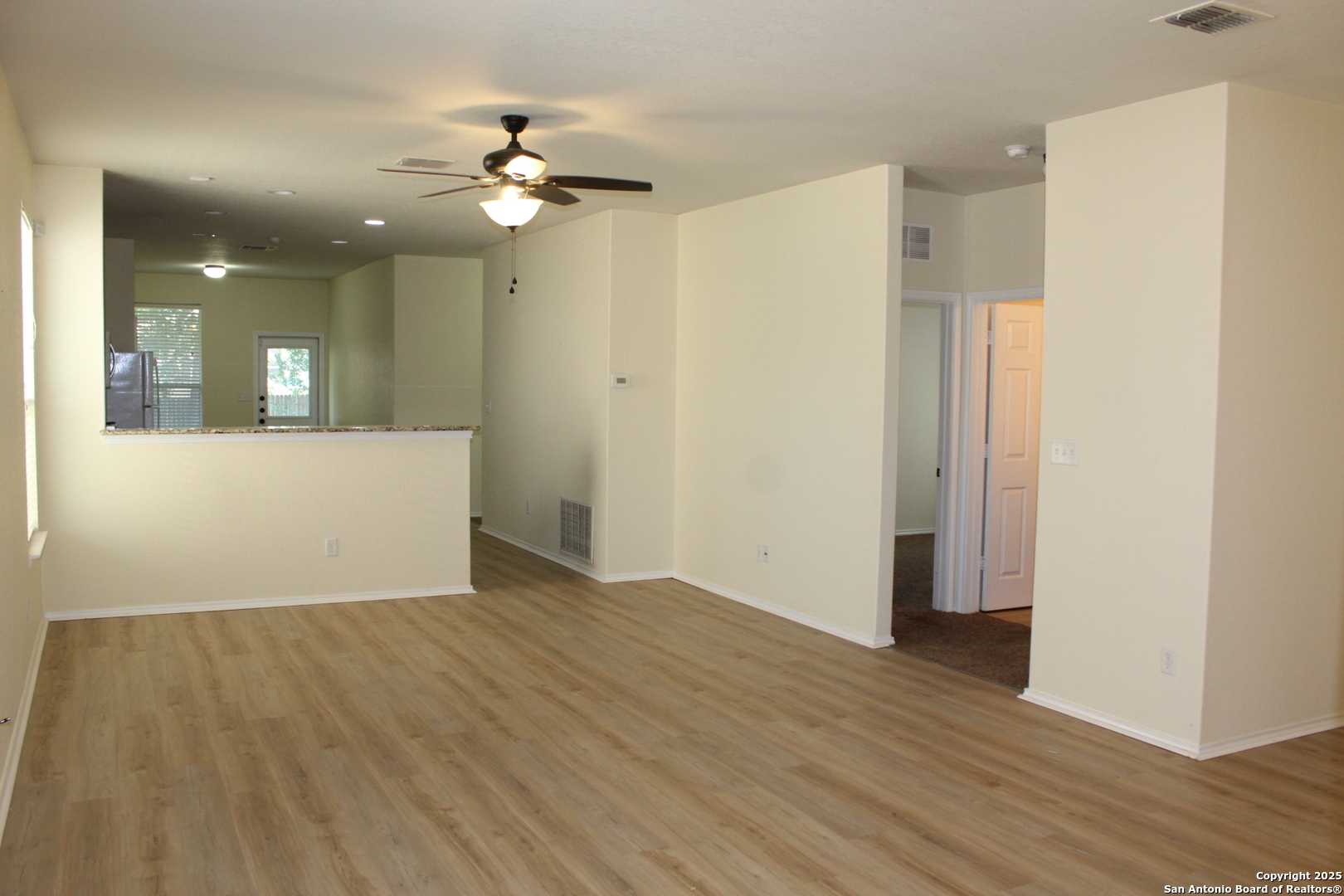 482 Walnut Crest Selma, TX 78154 - Photo 4 of 19 a view of a room with wooden floor and a ceiling fan