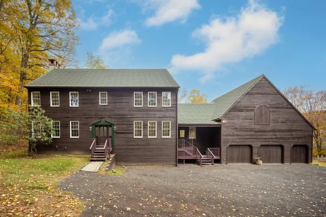 a view of a house with a yard and a fire pit