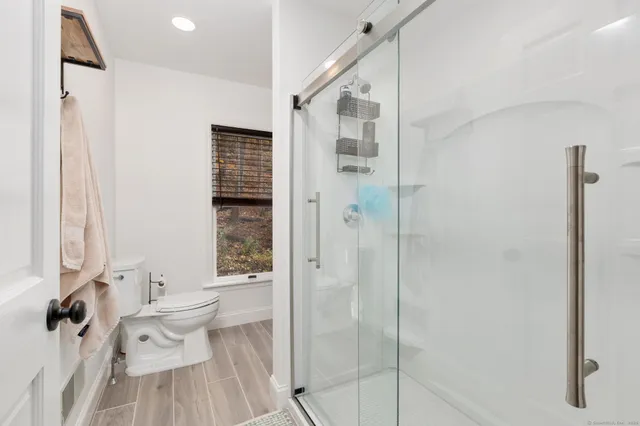 a bathroom with a bathtub shower sink and toilet