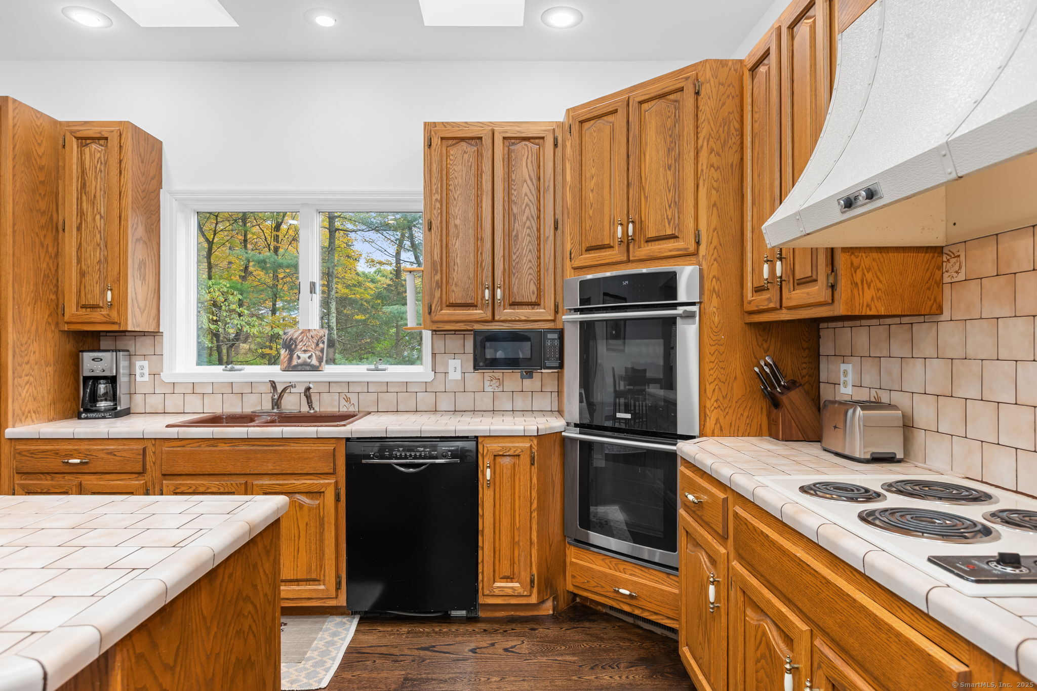 17 Curtis Drive Sherman, CT 06784 - Photo 14 of 34 a kitchen with a sink stove top oven and cabinets