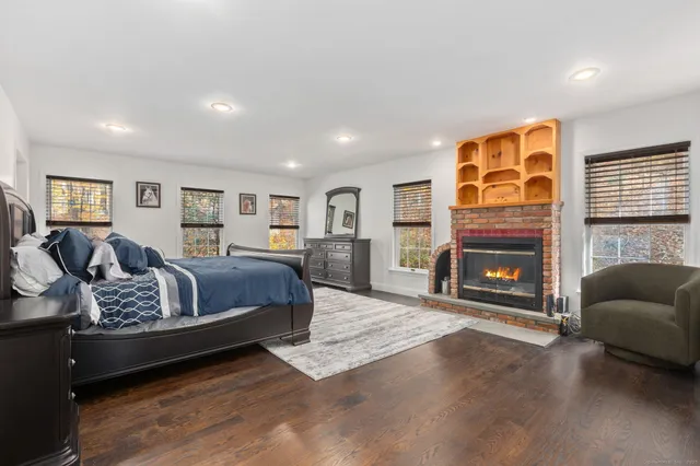 a spacious bedroom with a bed and a fireplace