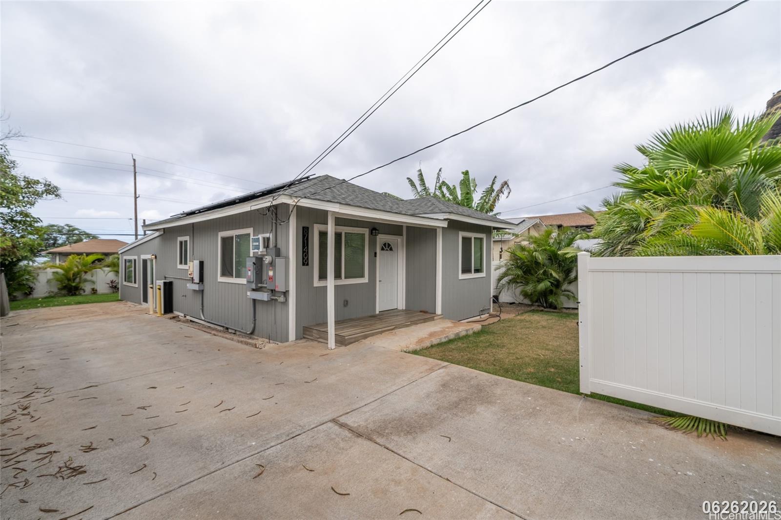 87-1409 Akowai Road Waianae, HI 96792 - Photo 2 of 25 a view of house with a yard and potted plants