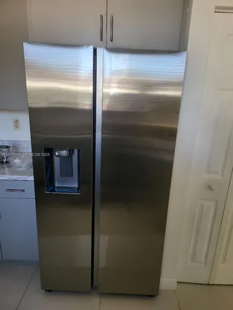 a kitchen with a sink appliances and cabinets