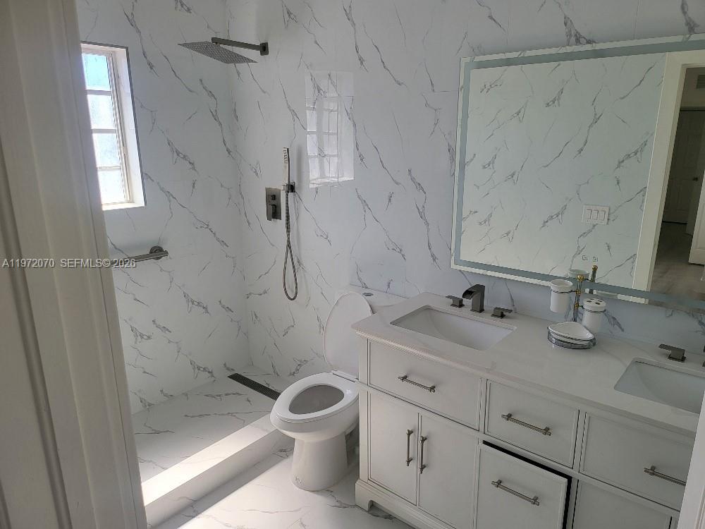 15843 Southwest 139th Street Miami, FL 33196 - Photo 24 of 39 a bathroom with a granite countertop sink toilet and shower